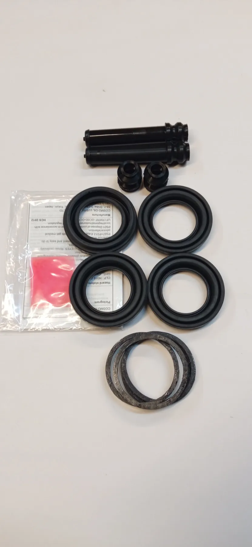 Ремкомплект суппорта MAZDA CX5, переднего (с порш) (к-т 12 дет+см). K0113361X, K0113371X "ROSTECO", артикул 22883 — фото автозапчасти
